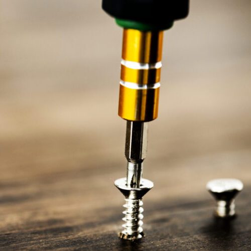 Macro shot of screw on wooden background